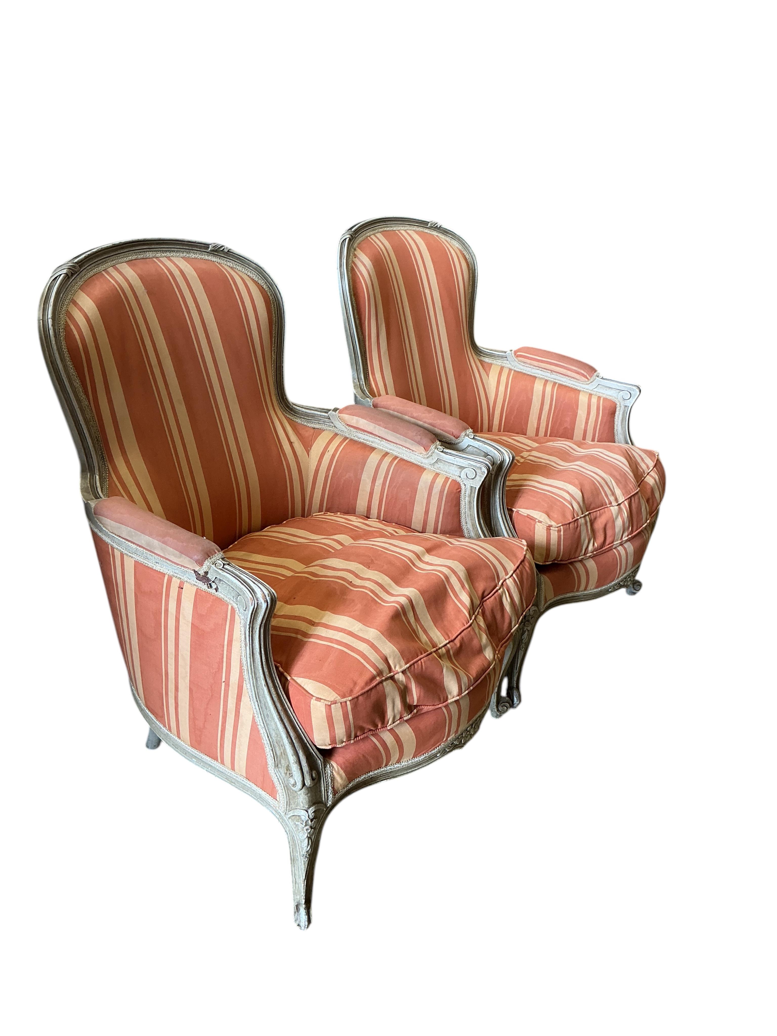 A pair of Louis XVI style painted upholstered armchairs, width 66cm, depth 60cm, height 88cm
